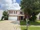 Two story home with brick and vinyl siding, red shutters, attached garage, mailbox, and partial cloudy sky at 6903 Governors Pointe Blvd, Indianapolis, IN 46217