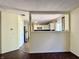 A vacant living room with new wood floors with a partial view to the kitchen at 6903 Governors Pointe Blvd, Indianapolis, IN 46217