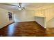 Upper living room area with hardwood floors, ceiling fan, and adjacent staircase at 6903 Governors Pointe Blvd, Indianapolis, IN 46217