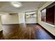 A vacant living room with new wood floors and partial view to the kitchen at 6903 Governors Pointe Blvd, Indianapolis, IN 46217