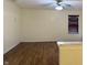 Spacious living room with hardwood floors, a window, and a ceiling fan at 6903 Governors Pointe Blvd, Indianapolis, IN 46217