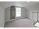 Bright attic space with a dormer window and exposed brick accent wall adding character at 701 Lincoln St, Indianapolis, IN 46203