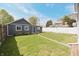 Backyard with a grassy lawn, fenced perimeter, and detached garage or shed at 701 Lincoln St, Indianapolis, IN 46203