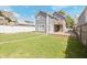 Charming home exterior features a large backyard, deck, and lush greenery at 701 Lincoln St, Indianapolis, IN 46203