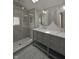 Modern bathroom featuring a glass-enclosed shower and double vanity sinks at 701 Lincoln St, Indianapolis, IN 46203