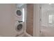 Stacked washer and dryer unit with adjacent exposed brick providing unique charm at 701 Lincoln St, Indianapolis, IN 46203