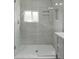 Bright, glass-enclosed shower features a built-in niche and a modern shower head at 701 Lincoln St, Indianapolis, IN 46203