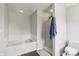 Bright bathroom with a large bathtub and shower with a frosted glass door at 7157 Chemistry Ct, Indianapolis, IN 46239