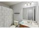 Small bathroom with a toilet, sink, shower with curtain, and mirror at 7157 Chemistry Ct, Indianapolis, IN 46239