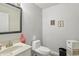 Cozy bathroom with a toilet, sink, and mirror at 7157 Chemistry Ct, Indianapolis, IN 46239