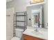 Bathroom featuring a toilet, sink, mirror and storage shelf at 7157 Chemistry Ct, Indianapolis, IN 46239