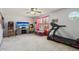 Bedroom with a TV, arcade game, treadmill, and lots of natural light at 7157 Chemistry Ct, Indianapolis, IN 46239