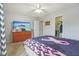 Bright bedroom with a TV, closet, ceiling fan, and view of the bed at 7157 Chemistry Ct, Indianapolis, IN 46239
