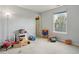 Bright bedroom featuring a window, neutral walls, and a variety of colorful toys at 7157 Chemistry Ct, Indianapolis, IN 46239