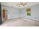 Bedroom featuring a ceiling fan, carpet and a bright view of the outdoors at 7157 Chemistry Ct, Indianapolis, IN 46239