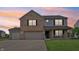 Charming two-story home features a brick facade, covered porch, and attached two-car garage at 7157 Chemistry Ct, Indianapolis, IN 46239
