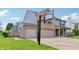 This charming home boasts a basketball hoop over a spacious driveway and an attached two-car garage at 7157 Chemistry Ct, Indianapolis, IN 46239