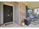 Cozy front porch with rocking chairs and a 'Welcome Friends' doormat inviting guests inside at 7157 Chemistry Ct, Indianapolis, IN 46239