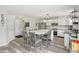 Well-lit kitchen with dining space and white cabinetry at 7157 Chemistry Ct, Indianapolis, IN 46239