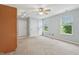 Living room featuring a ceiling fan, carpet and a bright view of the outdoors at 7157 Chemistry Ct, Indianapolis, IN 46239