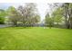 A large backyard with grass and some playground equipment at 7249 Tappan Dr, Indianapolis, IN 46268