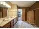 Full bathroom offering double sinks, tile flooring, and a walk-in closet at 7249 Tappan Dr, Indianapolis, IN 46268