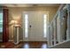 Foyer view with staircase, a white front door with glass panels, and hardwood floors at 7249 Tappan Dr, Indianapolis, IN 46268