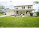 Charming two-story home featuring a welcoming front porch, manicured lawn, and an attached garage at 7249 Tappan Dr, Indianapolis, IN 46268