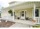 Inviting front porch with decorative hanging plants, seating, and a welcoming entrance at 7249 Tappan Dr, Indianapolis, IN 46268