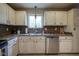 Bright kitchen showcases stainless steel dishwasher and sink with matching countertops at 7249 Tappan Dr, Indianapolis, IN 46268