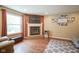 Living room with a brick fireplace, a large window, and warm-toned walls at 7249 Tappan Dr, Indianapolis, IN 46268