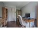 Office features a desk, comfortable chair, shelves, and wood floors at 7249 Tappan Dr, Indianapolis, IN 46268