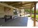 Covered back patio with a ceiling fan, stone facade, string lights, and landscaping at 7285 E County Road 900 N, Brownsburg, IN 46112