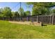 Lush backyard featuring a wooden fence, established lawn, and raised garden beds ready for planting at 7285 E County Road 900 N, Brownsburg, IN 46112