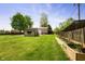 Expansive backyard featuring a shed, barn, and raised garden bed with vibrant greenery at 7285 E County Road 900 N, Brownsburg, IN 46112