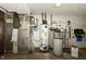 A basement utility room with a water heater, water softener, furnace, and electrical panel at 7285 E County Road 900 N, Brownsburg, IN 46112