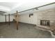 Unfinished basement with concrete floor, support beams, and brick fireplace at 7285 E County Road 900 N, Brownsburg, IN 46112