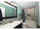 Bathroom features a framed mirror, dark vanity, neutral tile and shower with gray tile at 7285 E County Road 900 N, Brownsburg, IN 46112