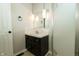 Bathroom with a black vanity, decorative lighting fixtures and a tiled shower with glass door at 7285 E County Road 900 N, Brownsburg, IN 46112