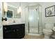 Bathroom features a framed mirror, dark vanity, corner shower and neutral tile floor at 7285 E County Road 900 N, Brownsburg, IN 46112