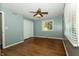 Bedroom with wood floors, ceiling fan, and a view of the backyard through the window at 7285 E County Road 900 N, Brownsburg, IN 46112