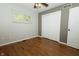 Bedroom with hardwood floors, light gray walls, one window with blinds, and closet at 7285 E County Road 900 N, Brownsburg, IN 46112