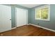 Bedroom with hardwood floors, light blue walls, one window with blinds, and closet at 7285 E County Road 900 N, Brownsburg, IN 46112