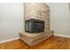 Stone fireplace featuring a black fireplace insert and floating shelves at 7285 E County Road 900 N, Brownsburg, IN 46112