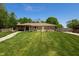 Charming single-story home featuring a lush green lawn, stone facade, and a welcoming stone pathway at 7285 E County Road 900 N, Brownsburg, IN 46112