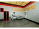 Spacious garage with gray walls, red trim, and exposed ceiling, featuring a workbench and Craftsman cabinets at 7285 E County Road 900 N, Brownsburg, IN 46112