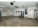 Spacious garage with white walls, utility sink, shelving, and access to the backyard at 7285 E County Road 900 N, Brownsburg, IN 46112