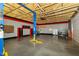 Large garage space with a two post lift, cabinets, pegboard, and epoxy flooring at 7285 E County Road 900 N, Brownsburg, IN 46112