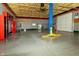 Expansive garage space with an auto lift, overhead door, and ample storage at 7285 E County Road 900 N, Brownsburg, IN 46112