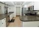 Bright kitchen with stainless steel appliances, white cabinets and a decorative tile ceiling at 7285 E County Road 900 N, Brownsburg, IN 46112